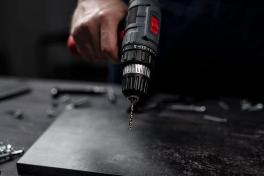 Man Holds Screwdriver In Hands Close-Up