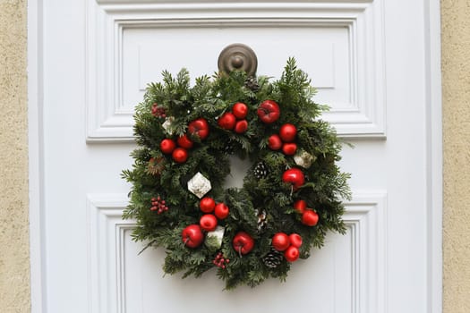 Christmas wreath with branches and red apples