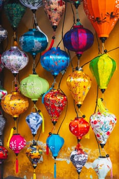 Colorful silk Chinese lanterns decorate the wall of a house in the old town in Hoi An in Asia