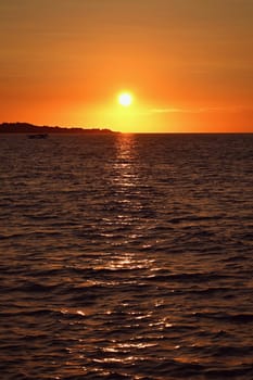 Beautiful colourful sunset on the beach with the sea and waves. A concept for travel, holidays and summer holidays by the sea. Greece - Corfu island - Agios Georgios