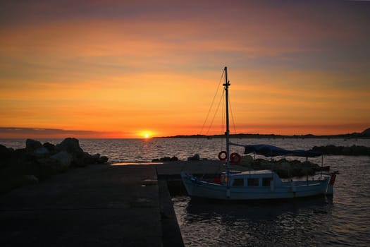 Beautiful colourful sunset on the beach with the sea and waves. A concept for travel, holidays and summer holidays by the sea. Greece - Corfu island - Agios Georgios