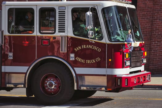 Capture the essence of bravery and community service with this striking image of a San Francisco Fire Department truck. Seen in its iconic red color, the vehicle is well-equipped and ready to respond to emergencies. Whether it's for a news article, public service campaign, or educational material, this photo conveys urgency, preparedness, and the valor of our first responders