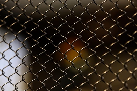 Captivating in its simplicity, this photograph features an array of chain link fences that form a compelling geometric pattern. The composition of the fences creates a harmonious blend of light and shadow, transforming a common, utilitarian object into a work of art. This photo captures the unexpected beauty found in everyday life.