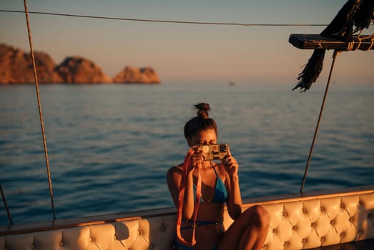 A woman captures a serene and beautiful sunset moment while relaxing on a boat, truly enjoying nature and tranquility