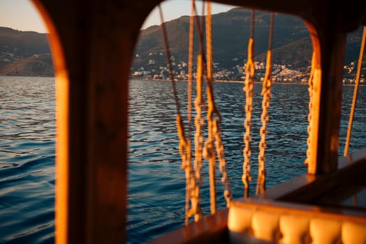A peaceful scene of a small boat gliding gracefully over the water at sunset, beautifully reflecting on its surface