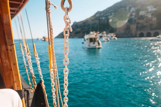 A beautiful view of boats sailing in clear blue waters, with a picturesque hillside in the background