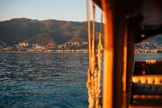 A serene, peaceful sunset view from a boat, showcasing beautiful mountains and calm waters all around
