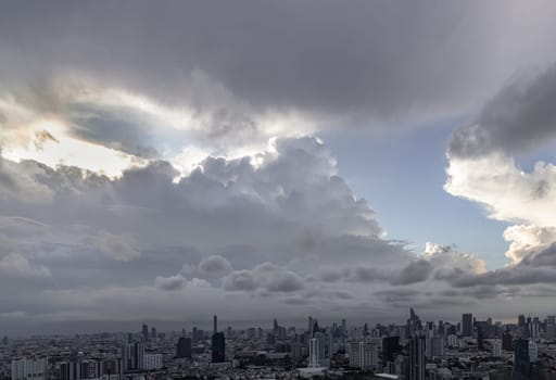 Bangkok, Thailand - 04 Aug 2024 - Beautiful Clouds in the Sky over Large Metropolitan City of Bangkok. View of Skyscrapers and Dramatic Sky before Sunset, Space for text, Selective focus.
