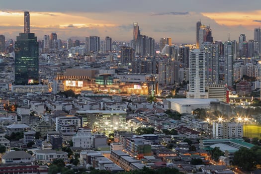 Bangkok, Thailand - 15 Aug 2024 - Bangkok city skyscrapers after sunset with Dramatic sky background before Sunset. View of Beautiful Clouds in the Sky over Large Metropolitan City, Copy space, Selective focus.