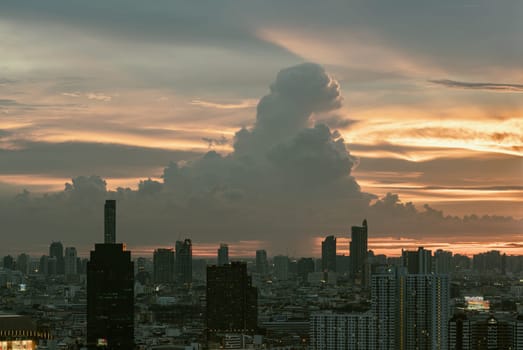 Bangkok, Thailand - 23 Aug 2024 - View of Beautiful Clouds in the Sky over Large Metropolitan City. Bangkok city skyscrapers after sunset with Dramatic sky background before Sunset, Space for text, Selective focus.