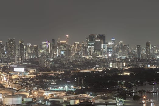 Bangkok, Thailand - 16 Sep, 2024 - City night view of Bangkok city skyscrapers after sunset. Bangkok downtown cityscape in Business district with bright glowing lights at night, Copy space, Selective focus.