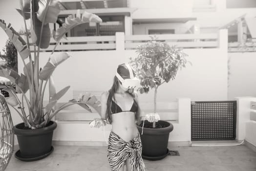 A skilled dancer poses elegantly in a lush, enchanting backdrop, creating a stunning visual in black and white