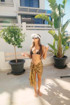 A young woman joyfully enjoys virtual reality outdoors, seamlessly blending technology with leisure