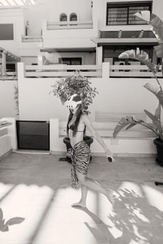 A figure moves with grace and poise through a bright sunlit urban space, showcasing the beauty of minimalistic design