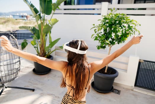 A person wearing a VR headset is relishing an immersive and thrilling experience while enjoying the outdoors