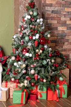 Christmas tree branches on white background. Closeup of decorated fir branches with red and silver baubles