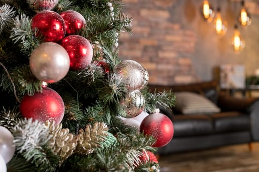 Christmas tree branches on white background. Closeup of decorated fir branches with red and silver baubles