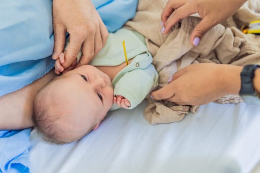 A nurse is taking a baby's temperature in the hospital. The gentle and careful procedure ensures the baby's comfort and well-being, allowing for accurate monitoring of their health.