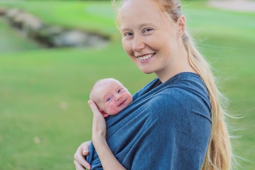Mom walks with her newborn baby in a sling. This moment highlights the close bond between mother and child, promoting comfort, security, and the benefits of babywearing in everyday life.