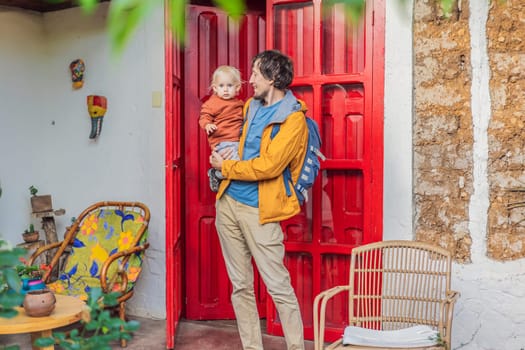 Father and his son tourists in a colonial house in San Cristobal de las Casas, Mexico. Cultural exploration, architecture, and travel experience concept.