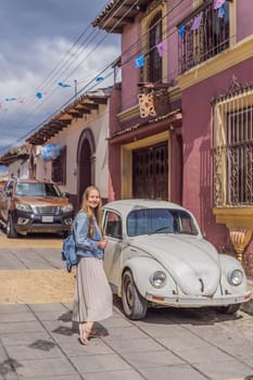 Female tourist walks through the colonial streets San Cristobal de las Casas, Mexico. Cultural exploration, architecture, and travel experience concept.