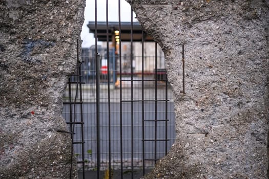Hole in Broken Berlin wall between East and west Berlin, symbol of the Cold War. Concept of freedom and independence.