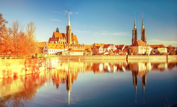 Autumn view on the center historical part of the city Wroclaw with reflection in water of Odra