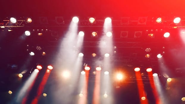glowing ceiling spotlights lights the stage during the concert