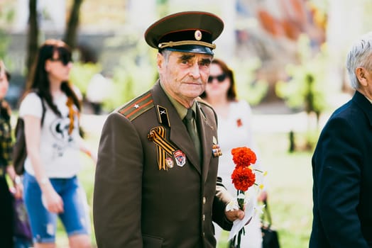 VICHUGA, RUSSIA - MAY 9, 2016: A veteran of World War II on the Victory day Parade in Russia. The March Of The Immortal Regiment, May 9