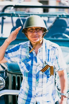 Man in a military helmet at the Parade in Honor of Victory Day in World War II, May 9, Russia