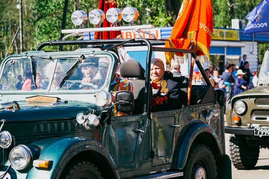 VICHUGA, RUSSIA - MAY 9, 2016: Veterans on car on the march of the immortal regiment and the parade on May 9 on Victory Day. Vichuga, Russia