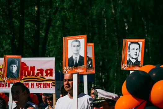 VICHUGA, RUSSIA - MAY 9, 2015: Immortal Regiment - people with portraits of their relatives, participants in the Second World War, on the Victory Day parade
