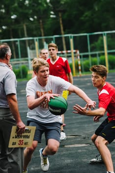 VICHUGA, RUSSIA - JUNE 11, 2016: Teenagers playing streetball on the celebration of the city of Vichuga, Russia