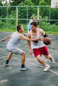 VICHUGA, RUSSIA - JUNE 11, 2016: Teenagers playing streetball on the celebration of the city of Vichuga, Russia