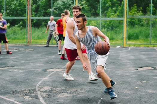 VICHUGA, RUSSIA - JUNE 11, 2016: Teenagers playing streetball on the celebration of the city of Vichuga, Russia