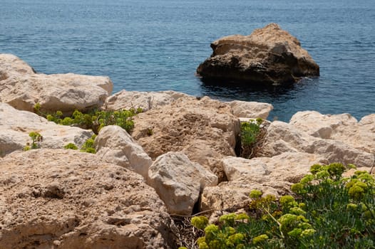 A beautiful coastal scene featuring rocky cliffs and a calm blue ocean, perfect for nature and travel themes.