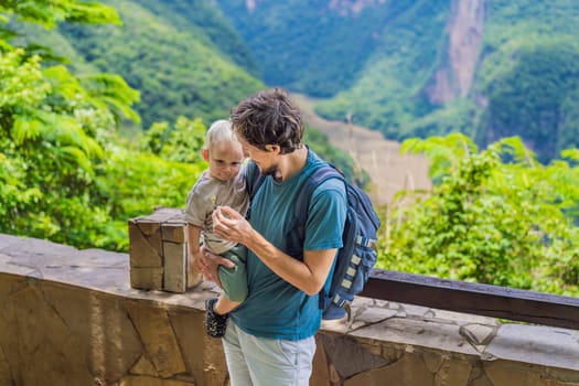 Dad and his baby son travelers exploring Sumidero Canyon National Park, Mexico. Adventure, natural exploration, and travel experience concept.