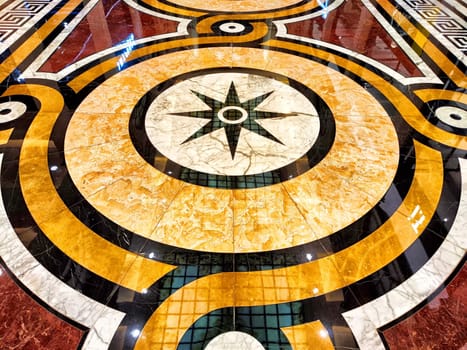 Beautifully crafted marble floor showcases geometric shapes and intricate patterns, accentuating a central star design.