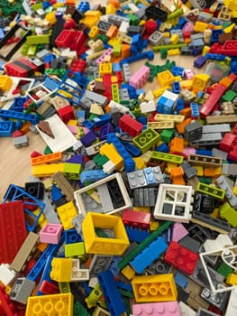 A vibrant collection of Lego blocks is scattered on a table, showcasing a variety of colors and shapes, perfect for inspiring creativity in building projects.