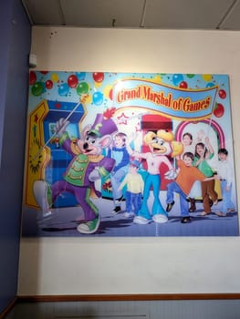 Pearl City - August 8, 2024: A vibrant mural displays animated characters Chuck E. Cheese and Helen Henny engaging in festivities at an entertainment venue in Hawaii, creating a lively atmosphere for families.