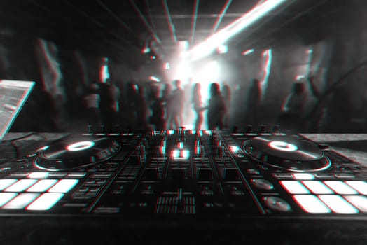professional DJ mixer controller for mixing music in a nightclub with dancing people on the dance floor in the background. Black and white photo with glitch effect and small grain