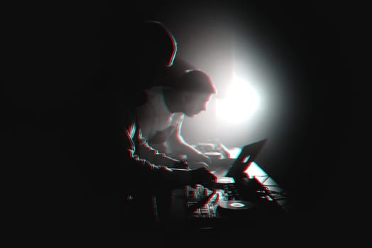 silhouette of DJs playing the mixer on stage at a party in a nightclub. Black and white photo with glitch effect and small grain