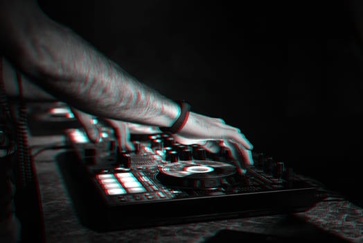 hands on DJ playing music on professional mixer controller in nightclub at party. 3D glitch effect