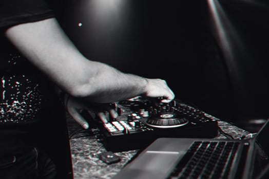 hands DJ playing electronic contemporary music on the mixer console at a concert in a nightclub. 3D glitch virtual reality effect