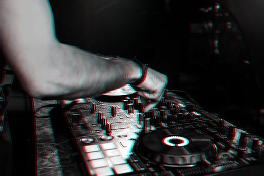 DJ mixes music on a professional controller Board in a nightclub at a party. 3D glitch effect