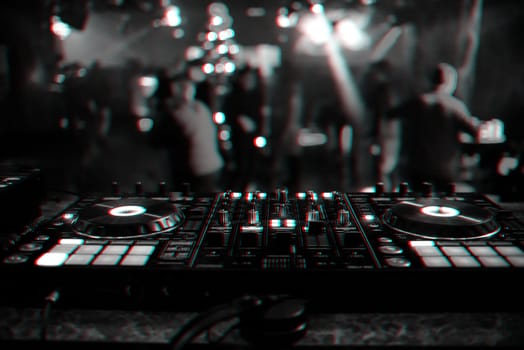 DJ mixer controller Board for mixing music in a nightclub at a party. Black and white photo with glitch effect and small grain