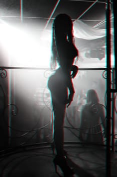 slender girl dancer posing at a nightclub with a sexy figure and body. Black and white photo with glitch effect and small grain