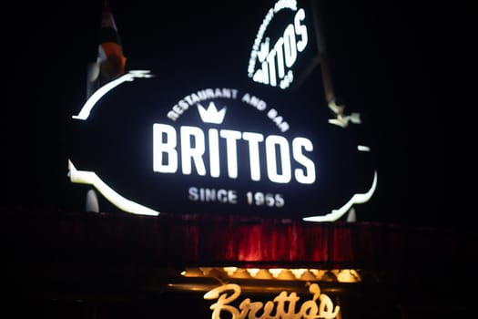 Goa, India - 16th Aug 2024: Night lit sign showing famous shack Brittos on baga beach with colorful lights popular tourist spot for dining on sand karaoke and more