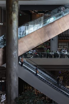 Bangkok, Thailand - 28 Sep, 2024 - The side view of the escalators for facilities inside ICONSIAM shopping mall, Structural interior design of escalator is shaped like the letter K. Dark tone, Space for text, Selective focus.