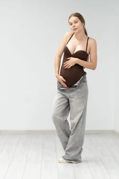 pregnancy happy expectant positive maternity female motherhood tummy background girl jeans mother